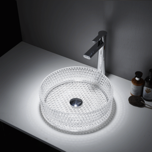 Lavatório de pousar redondo Mumbai em vidro transparente com acabamento mate, instalado sobre tampo